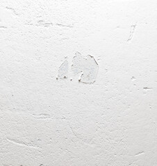 A white wall with a hole in it