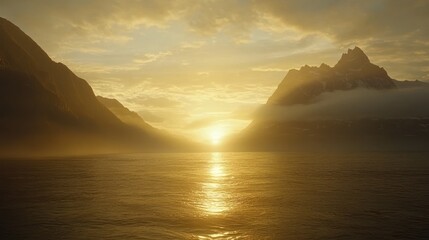 Naklejka premium Golden sunlight breaks through the clouds over mountainous waterscape