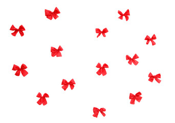 A bunch of red bows are flying in the air
