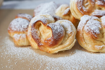 Vanilla buns with icing sugar.