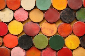 Colorful wax crayons arranged on yellow background, overhead shot, craft project