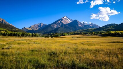 Majestic mountain range standing tall over expansive golden fields under a clear blue sky : Generative AI