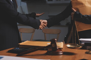 Attractive young lawyer in office Business woman and lawyers discussing contract papers with brass scale on wooden desk in office. Law, legal services, advice, Justice and real estate concept.