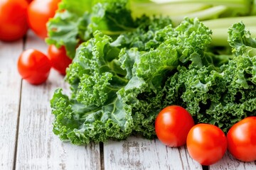 A collection of fresh green kale leaves and vibrant red tomatoes showcasing a mix of colors for healthy eating.
