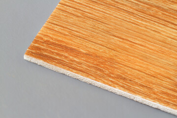 Close-up of a wood grain linoleum sample. Practical modern flooring.