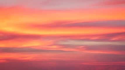 Obraz premium Crimson Canvas: Vibrant hues of orange, red, and pink blend together across the sky, creating a breathtaking display. The sky transforms into a stunning spectacle of nature's artistry. 