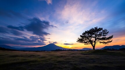 Stunning Sunset Over Mountain Landscape Featuring a Lone Tree for Scenic Beauty : Generative AI