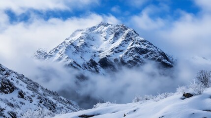 Obraz premium Majestic snowcapped mountain peak surrounded by rolling clouds : Generative AI
