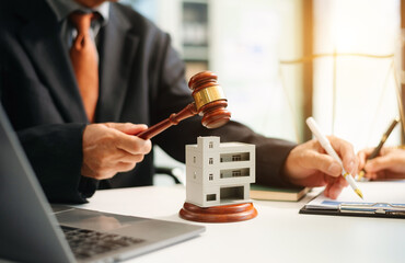 Lawyer handling house foreclosure law with gavel and home model. Legal decision, bankruptcy, and...