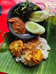 Egg salad. Rice with fresh vegetables, with traditional Indonesian chili sauce, with fried egg as a side dish.