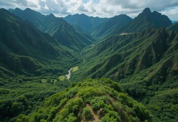 Fototapeta premium Aerial view of a waterfall surrounded by lush green forests and mountains in Tahiti