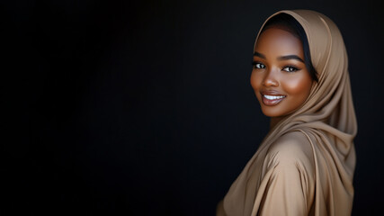 Fototapeta premium Black muslim woman wearing traditional abaya and hijab isolated on black background