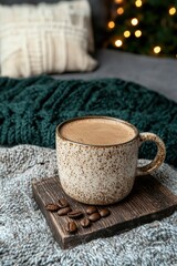 Cozy winter scene with coffee and Christmas lights.