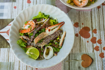 A bowl of special food of dry egg yellow noodle with crawfish, shrimp and crab, sold in Chanthaburi province, Thailand