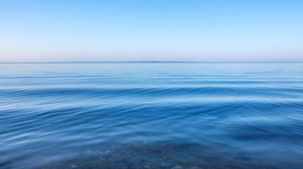 Obraz premium Calm and peaceful surface of the ocean reflecting clear blue sky during sunset : Generative AI