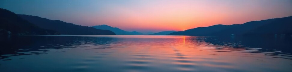Fototapeta premium Gentle ripples disturb the lake's calm surface at dusk, peaceful ambiance, water