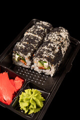 sushi on a black plate