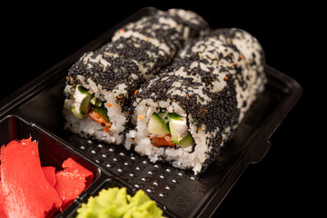 sushi on a black plate