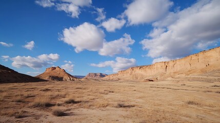 Naklejka premium Expansive Desert Landscape with Rocky Formations Against Vibrant Cloudy Sky : Generative AI