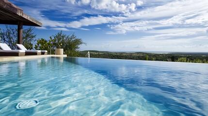Obraz premium Inviting Infinity Pool Sparkling Under a Bright Blue Sky with Lush Greenery in the Background : Generative AI