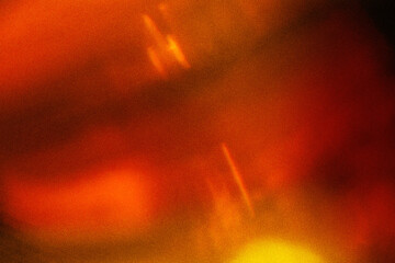 Light orange warm color light leak on dark background for design use and special effects.