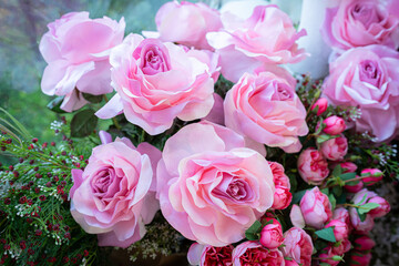 Valentine's day concept,close up Sweet color of artificial rose bouquet of red and pink roses Put with rose vase weddings interiors and decorations In a restaurant background