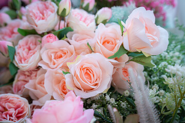 Valentine's day concept,close up Sweet color of artificial rose bouquet of red and pink roses Put with rose vase weddings interiors and decorations In a restaurant background