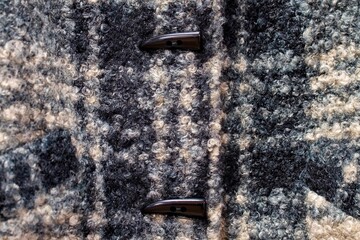 Fragment of clothing. Wool coat. Wool background.