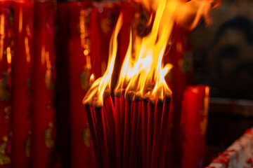 Burning red incense sticks in Chinese temple