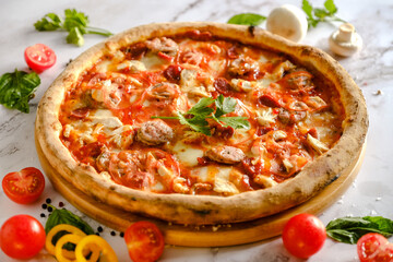 Appetizing, fresh pizza is on the table. Food from an Italian restaurant. Cooking pizza. Pizza ingredients.