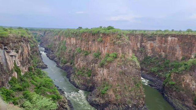 Scenic View of Victoria Falls Gorge as the Zambezi River plunges into the Batoka Gorge next to Victoria Falls Bridge