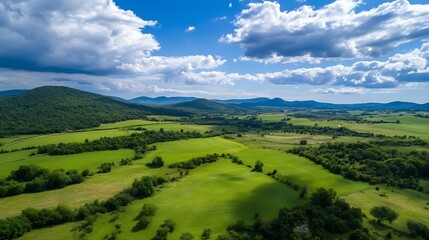Breathtaking Aerial View of Lush Green Rolling Hills Under Bright Blue Sky : Generative AI