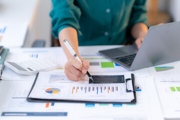 Data Analysis in Action: A focused individual meticulously reviews and annotates financial data...
