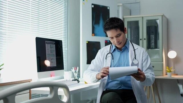 Doctor analyzing medical report and pointing at computer screen