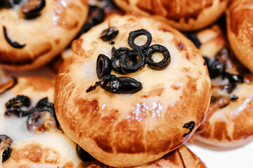 Round bun with black olives. Bakery. Bakery shop.