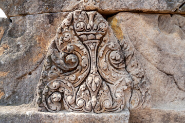 Statue at Castle sandstone walls of the main castle, Ancient architecture Sand Stone Castle in Buriram province, Thailand, Phanom Rung Historical Park architectural site.