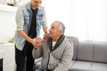Fototapeta premium Portrait of grandfather and his teen grandson smiling. Isolated white background