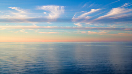 Fototapeta premium Serene Ocean Horizon at Sunset with Soft Cloudscape