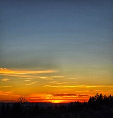 A breathtaking yellow-orange summer sunset over the Columbia River in the Pacific Northwest.