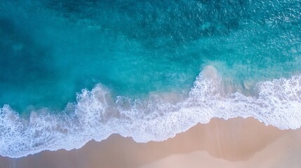 Fototapeta premium Aerial view of clear blue ocean waves crashing onto sandy beach during sunny day : Generative AI