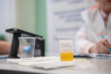A narcologist tests urine for drugs using an electronic device. 