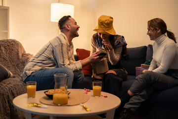 Friends giving gifts and celebrating birthday at home