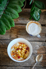 Rice pudding with caramelized apples. wooden background, side view	
