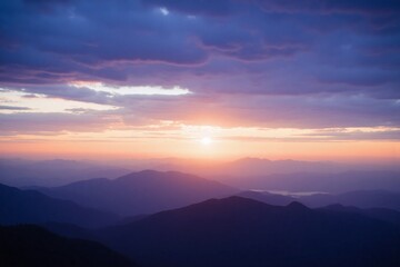 Obraz premium Sunrise or sunset over mountain range blue orange pink sky