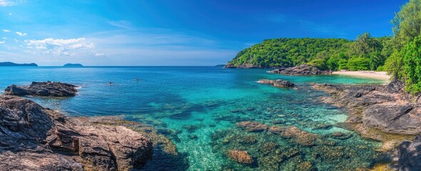 Tropical beach cove with crystal clear water and lush hills