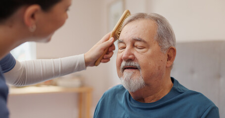 Nurse, support and elderly man with brush for hair care, assistance and helping hand at home....