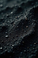 Black granular surface; deep shadows highlight the gritty texture , heavy texture, rough, stone texture