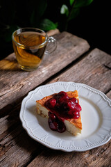 a piece of cheesecake with cherry sauce. cottage cheese casserole.