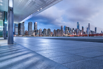 Empty square floors and city skyline with modern buildings at night in Chongqing
