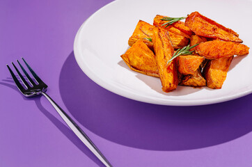 Crispy roasted sweet potato wedges on a white plate